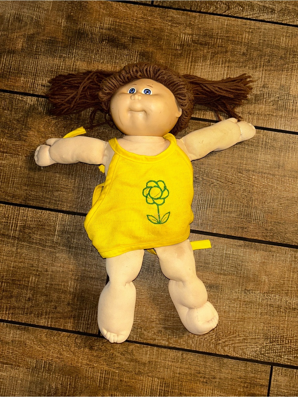 Vintage Cabbage Patch Kids soft-bodied doll with a vinyl head, brown yarn